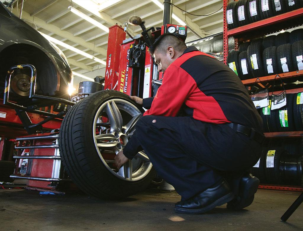 Tire mechanic working on a wheel